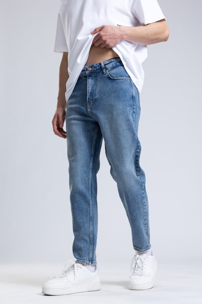 Denim Boyfriend Jeans - Light blue wash denim jeans designed with a slim straight fit for a clean everyday style. Features a soft faded finish, mid-rise waist, and classic five-pocket construction for lasting comfort. Easy to pair with tees, hoodies, or sneakers for a fresh casual streetwear look.