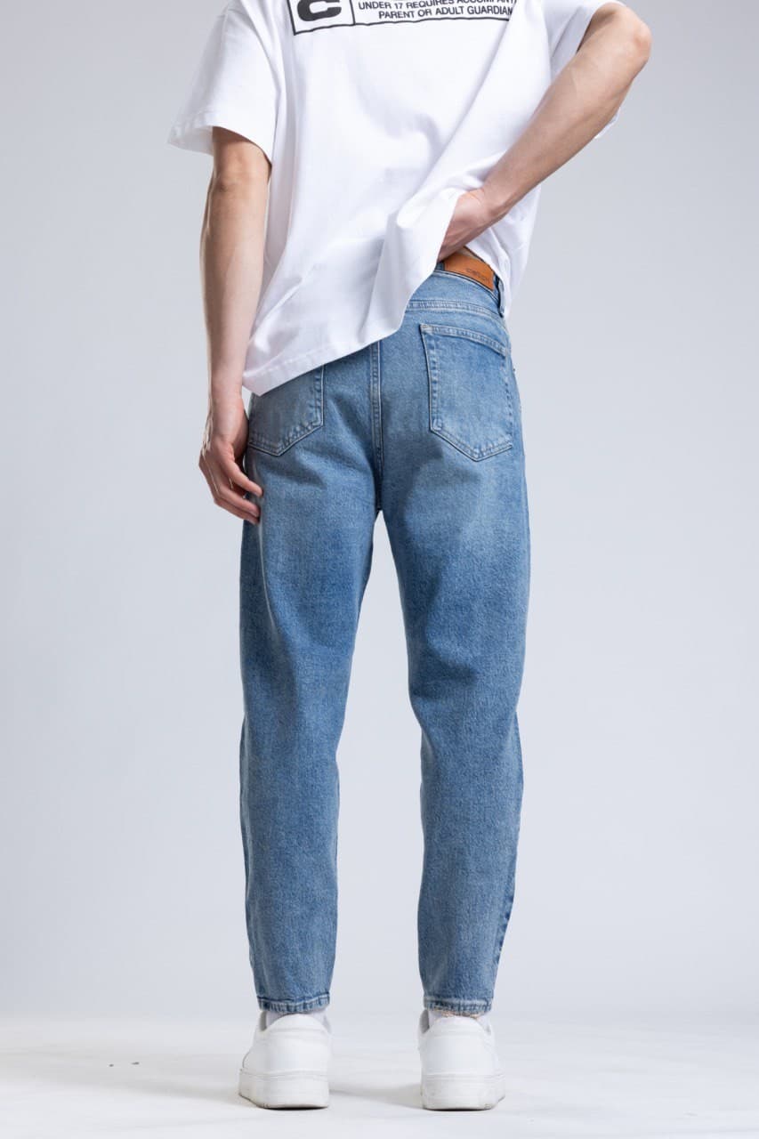 Denim Boyfriend Jeans - Light blue wash denim jeans designed with a slim straight fit for a clean everyday style. Features a soft faded finish, mid-rise waist, and classic five-pocket construction for lasting comfort. Easy to pair with tees, hoodies, or sneakers for a fresh casual streetwear look.