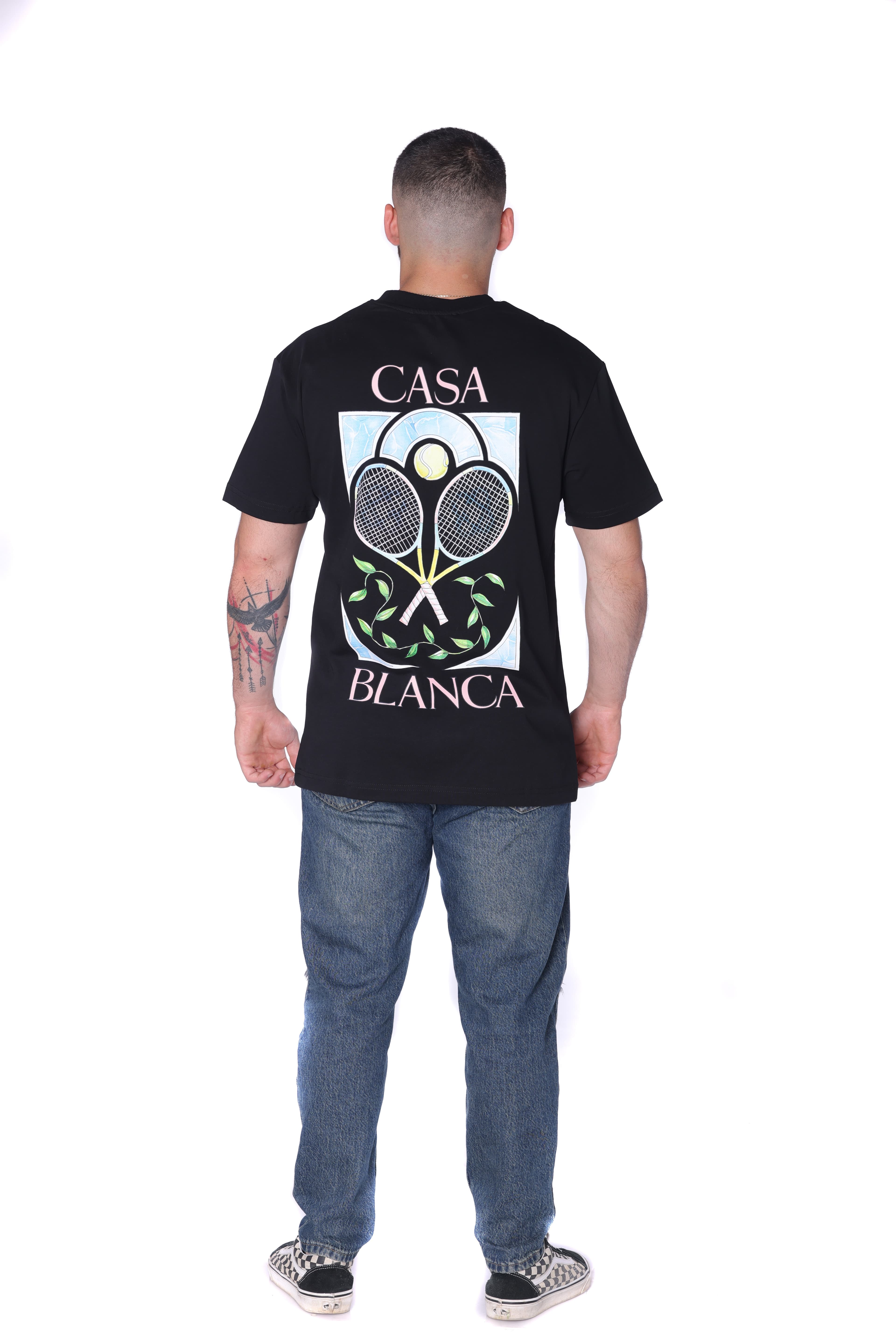 Black Oversized T-Shirt Casa Blanca Tennis - BLACK oversized t-shirt featuring a subtle front chest graphic and bold Casa Blanca-inspired artwork on the back with tennis racket design details. Made from soft breathable fabric with a relaxed fit for all-day comfort. A fresh premium streetwear piece perfect for casual summer looks and everyday styling.