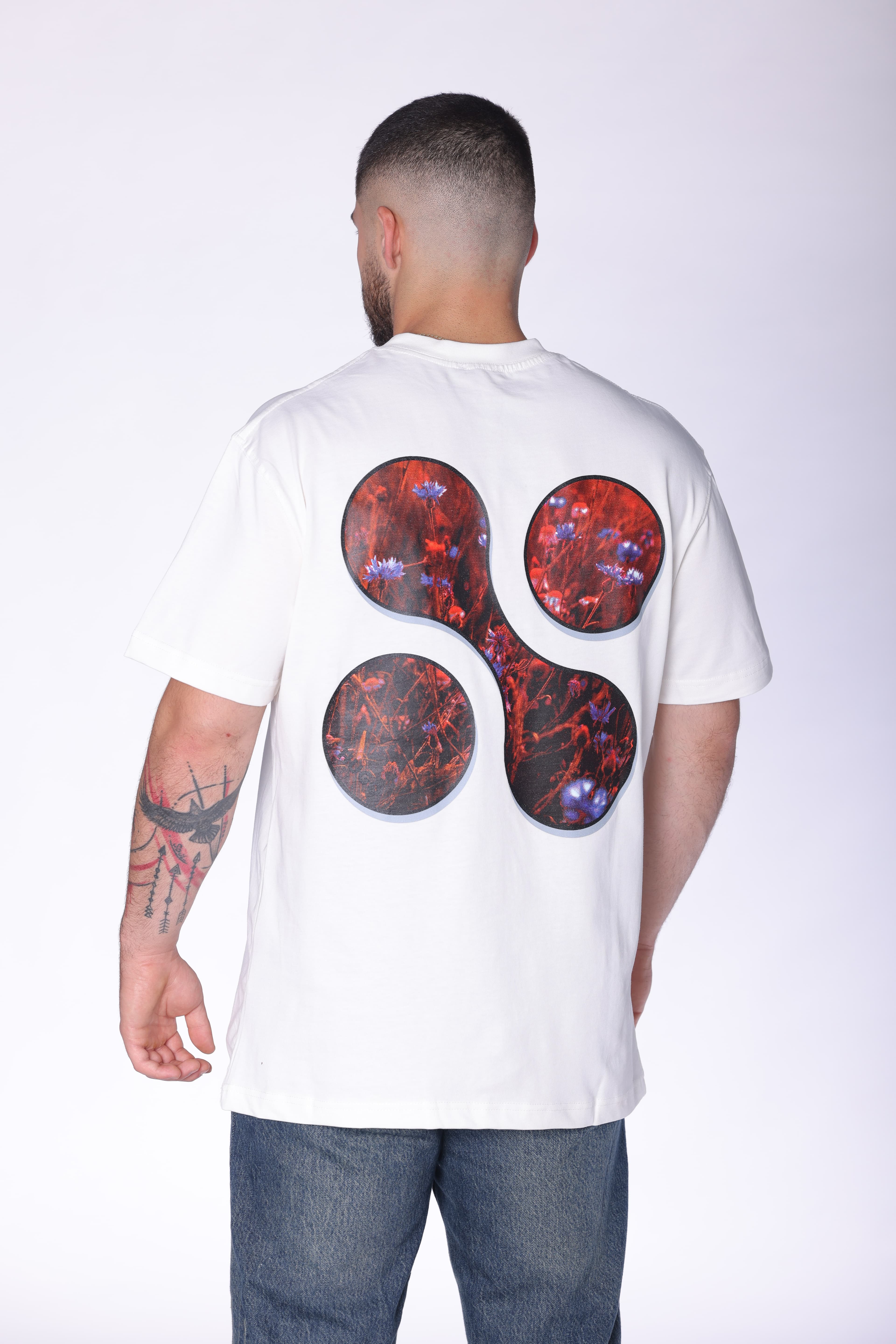 White Oversized Forever Inspired T-Shirt Hugo Boss - Modern white oversized t-shirt featuring a subtle front chest graphic and bold abstract floral artwork on the back. Crafted from soft breathable fabric with a relaxed fit for all-day comfort. A clean statement streetwear piece perfect for casual styling, layered looks, and everyday wear.