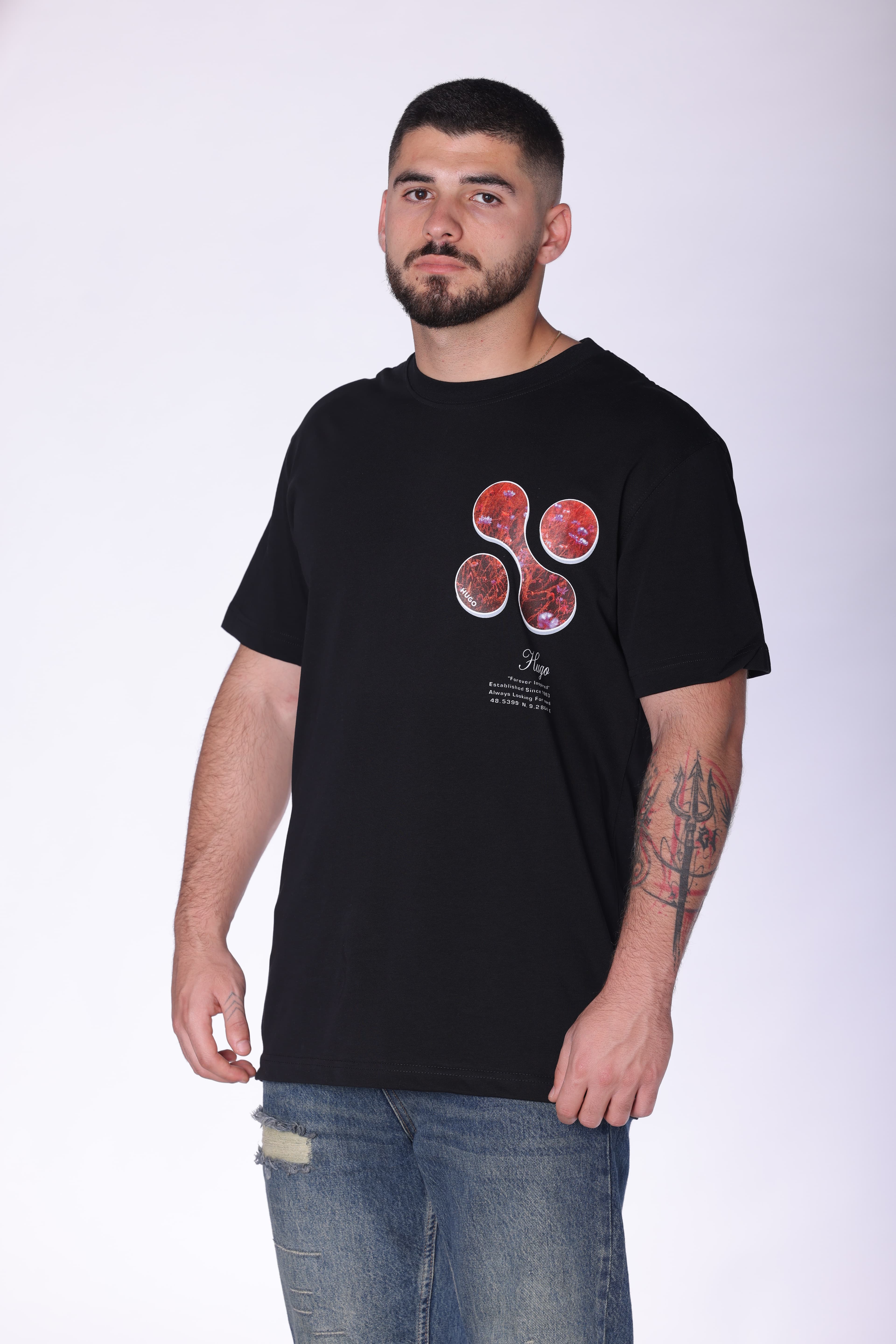 Black Oversized Forever Inspired T-Shirt Hugo Boss - Black oversized t-shirt featuring a subtle front chest graphic and bold abstract floral artwork on the back. Crafted from soft breathable fabric with a relaxed fit for all-day comfort. A clean statement streetwear piece perfect for casual styling, layered looks, and everyday wear.