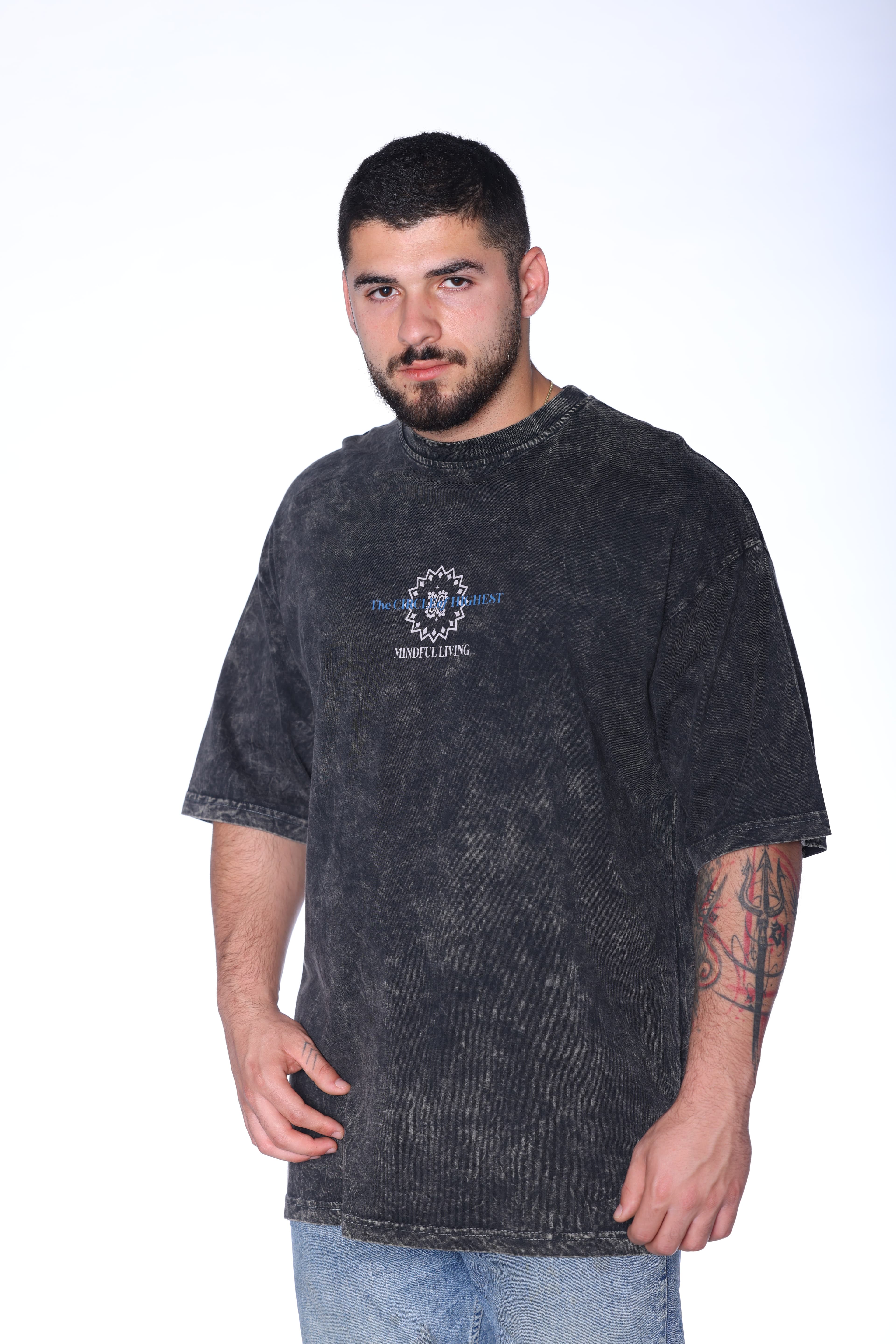 Oversized Washed Grey Mandala T-Shirt - Oversized washed black t-shirt featuring a minimal front chest graphic and bold mandala-inspired statement artwork on the back with blue and purple gradient details. Crafted from soft premium fabric with a vintage faded finish and relaxed fit for all-day comfort. A standout streetwear essential perfect for casual looks, layered outfits, and everyday wear.