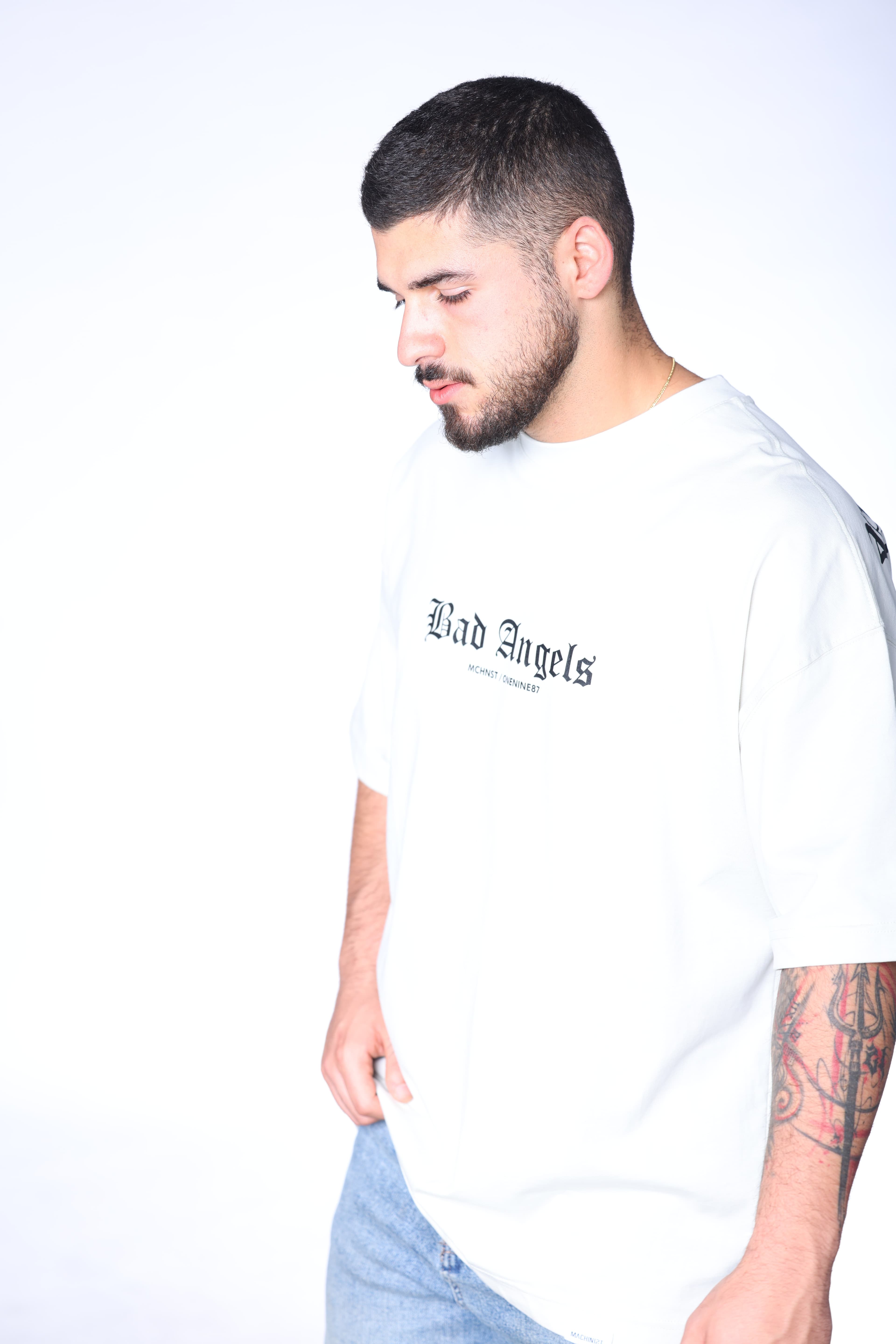 Oversized Ice Grey Bad Angels T-Shirt - Oversized ice grey t-shirt featuring bold Bad Angels gothic text on the front with statement graphic detailing on the back. Crafted from soft premium fabric with a relaxed fit for all-day comfort. A clean modern streetwear essential perfect for casual styling, layered outfits, and everyday wear.