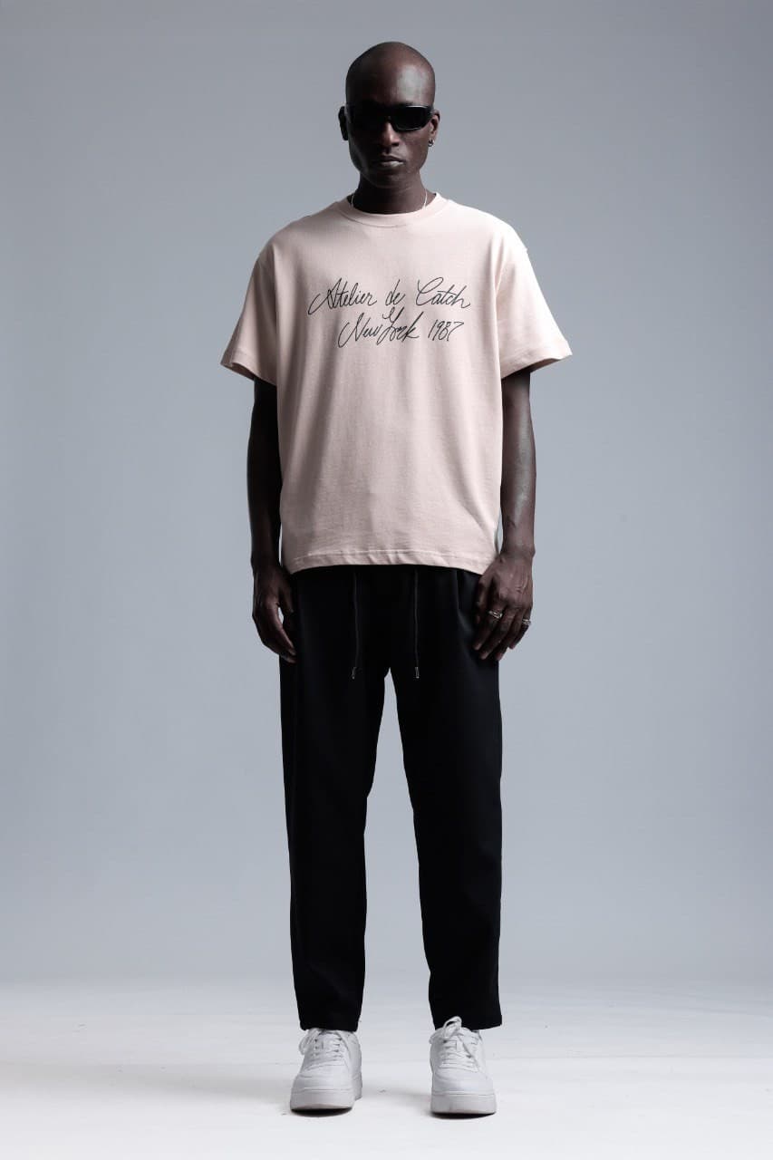 Oversized Sand Beige T-Shirt - Oversized sand beige t-shirt featuring elegant script typography across the front for a clean premium look. Crafted from soft breathable fabric with a relaxed fit for all-day comfort. A refined streetwear essential perfect for minimal styling, casual outfits, and elevated everyday wear.