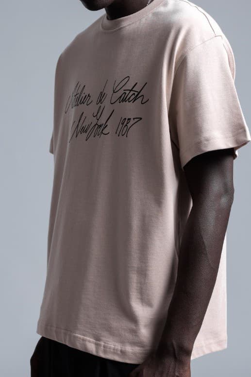 Oversized Sand Beige T-Shirt - Oversized sand beige t-shirt featuring elegant script typography across the front for a clean premium look. Crafted from soft breathable fabric with a relaxed fit for all-day comfort. A refined streetwear essential perfect for minimal styling, casual outfits, and elevated everyday wear.