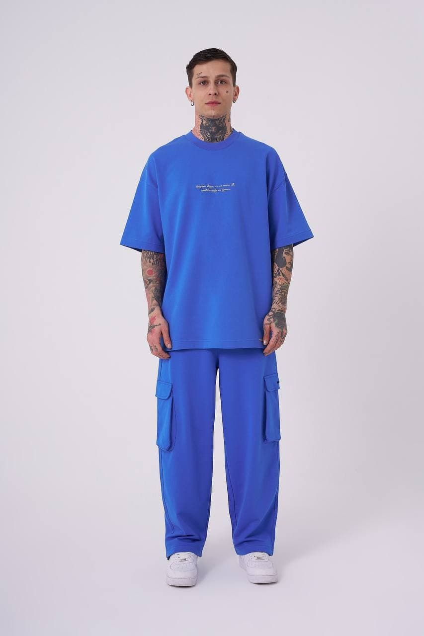 Oversized Electric Blue Snake T-Shirt - Oversized electric blue t-shirt featuring a minimal front chest print and bold back graphic with gothic Machinist lettering, snake artwork, and statement detailing. Crafted from soft premium fabric with a relaxed fit for all-day comfort. A standout streetwear piece perfect for bold casual looks, coordinated outfits, and everyday wear.