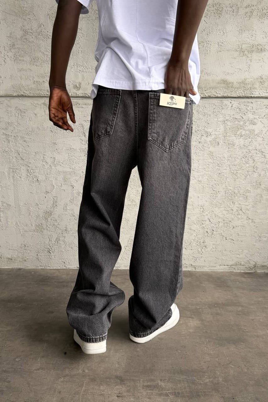 Relaxed Fit Baggy Jeans Charcoal Black - Relaxed fit baggy jeans in a washed charcoal black denim finish, featuring a loose straight-leg silhouette for a bold streetwear vibe. Made from durable premium denim with classic five-pocket styling and a comfortable oversized fit. Easy to pair with sneakers, hoodies, and oversized tees for an everyday urban look.