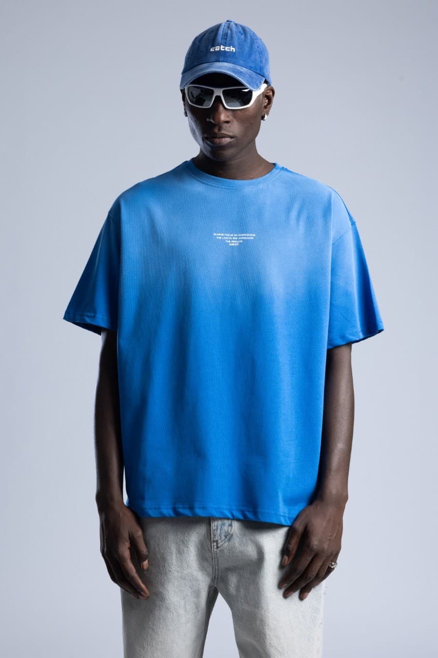 Oversized Electric Blue T-Shirt - Oversized fit t-shirt in a bold electric blue finish, designed with a clean minimal front detail for a modern streetwear look. Crafted from soft premium cotton with a relaxed drop-shoulder silhouette for all-day comfort. Easy to style with denim, cargos, or sneakers for a fresh everyday outfit.