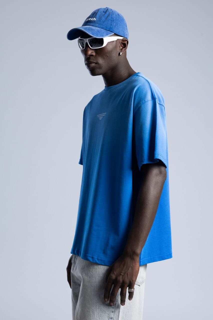 Oversized Electric Blue T-Shirt - Oversized fit t-shirt in a bold electric blue finish, designed with a clean minimal front detail for a modern streetwear look. Crafted from soft premium cotton with a relaxed drop-shoulder silhouette for all-day comfort. Easy to style with denim, cargos, or sneakers for a fresh everyday outfit.