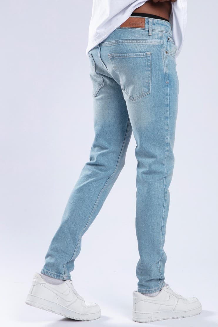 Ice Blue Denim Jeans - Slim fit jeans in an ice blue washed denim finish, designed with a clean tapered silhouette for a sharp everyday look. Crafted from comfortable premium denim with classic five-pocket styling and a modern streamlined fit. Perfect to pair with sneakers, tees, or jackets for a fresh casual outfit.