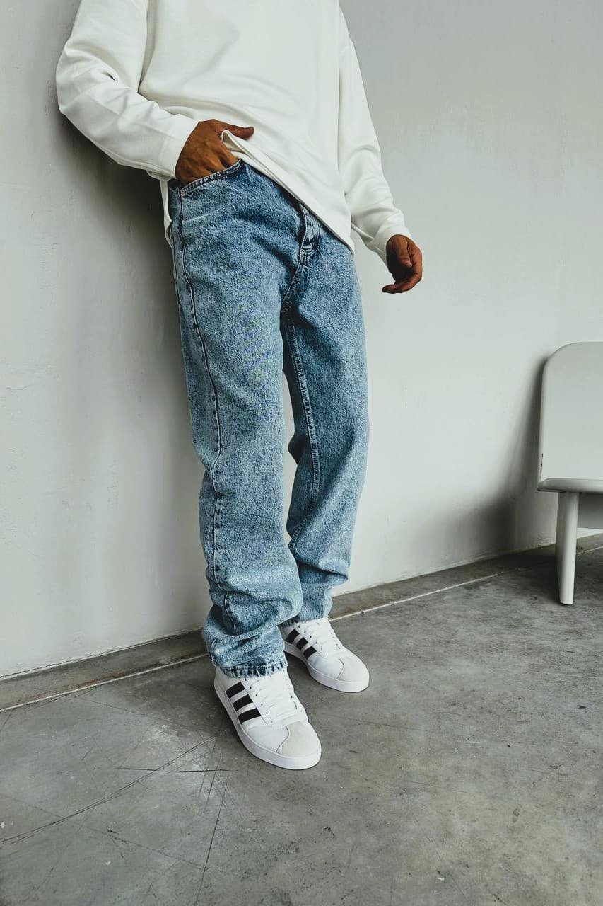 Relaxed-Fit Light Wash Baggy Denim Jeans - Relaxed-fit light wash denim jeans featuring a vintage-inspired faded finish for a clean, effortless look. Designed with a straight-leg cut that offers a comfortable, slightly loose silhouette—perfect for everyday wear. Made from durable denim with a soft feel, these jeans pair easily with sneakers for a casual streetwear vibe or can be styled up for a minimal, modern outfit.