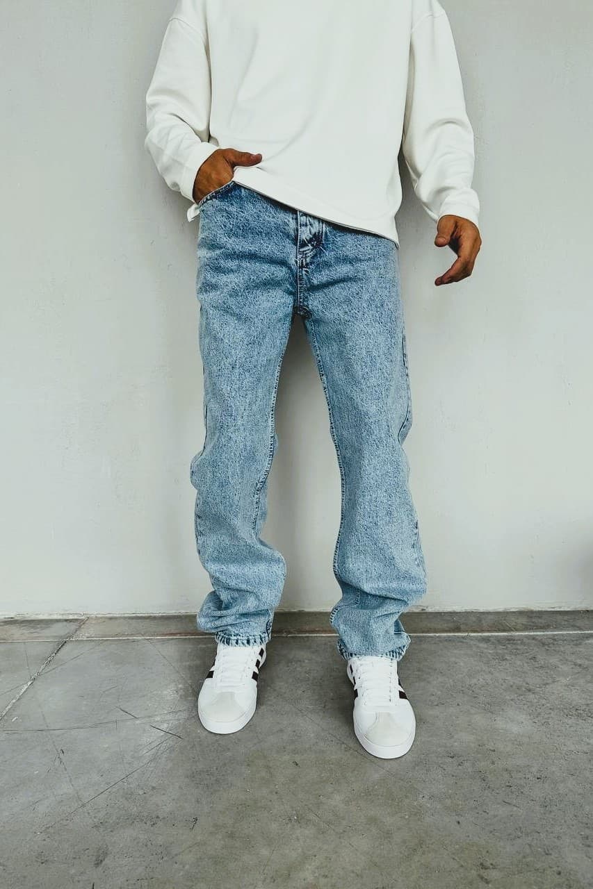 Relaxed-Fit Light Wash Baggy Denim Jeans - Relaxed-fit light wash denim jeans featuring a vintage-inspired faded finish for a clean, effortless look. Designed with a straight-leg cut that offers a comfortable, slightly loose silhouette—perfect for everyday wear. Made from durable denim with a soft feel, these jeans pair easily with sneakers for a casual streetwear vibe or can be styled up for a minimal, modern outfit.