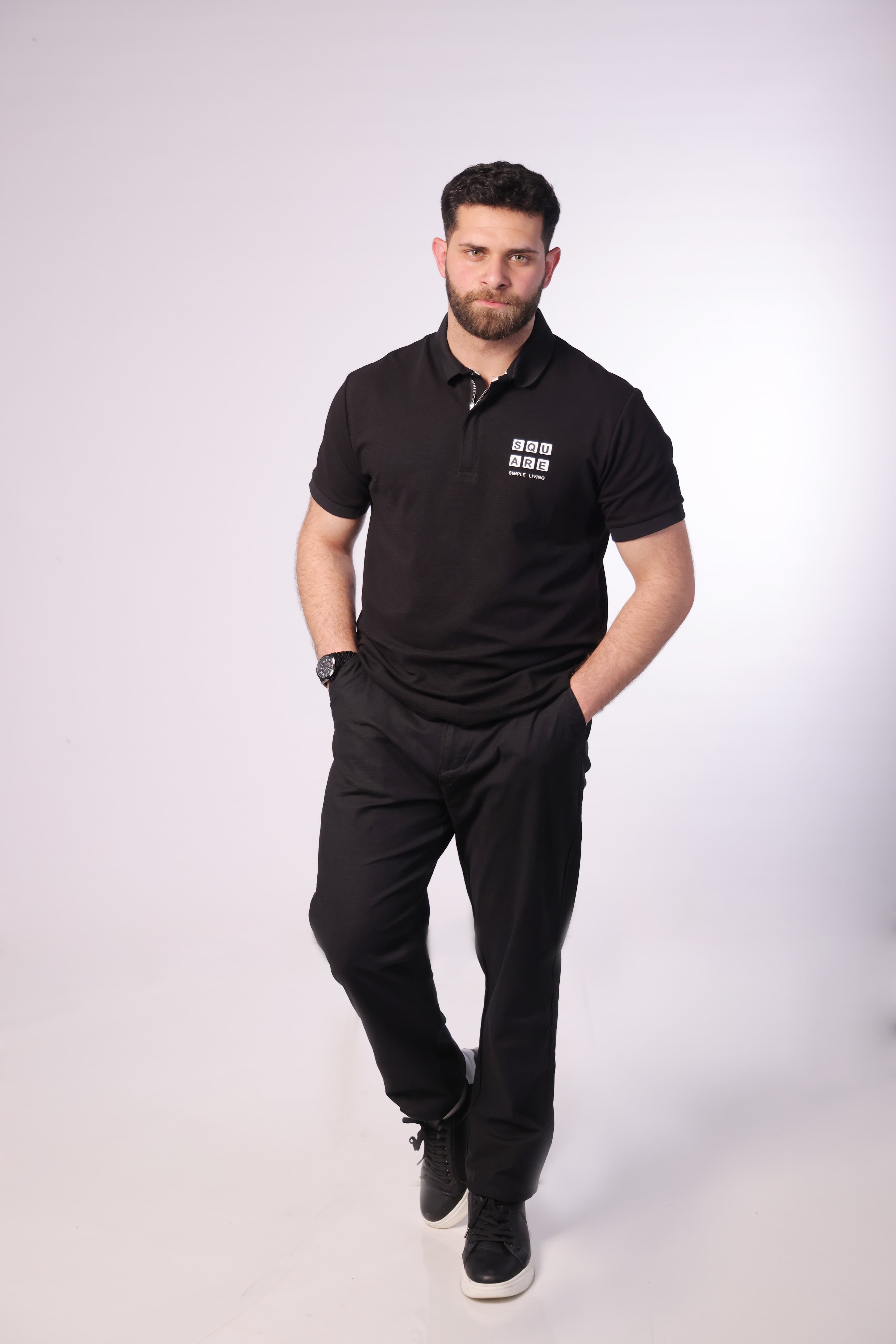 Slim-Fit Black Polo Shirt - Slim-fit black polo shirt designed for a clean and modern look. Featuring a structured collar with a subtle zip placket and a minimal chest print detail for a refined touch. Crafted from soft, breathable fabric that offers comfort while maintaining a sharp silhouette—perfect for smart-casual outfits or elevated everyday wear.
