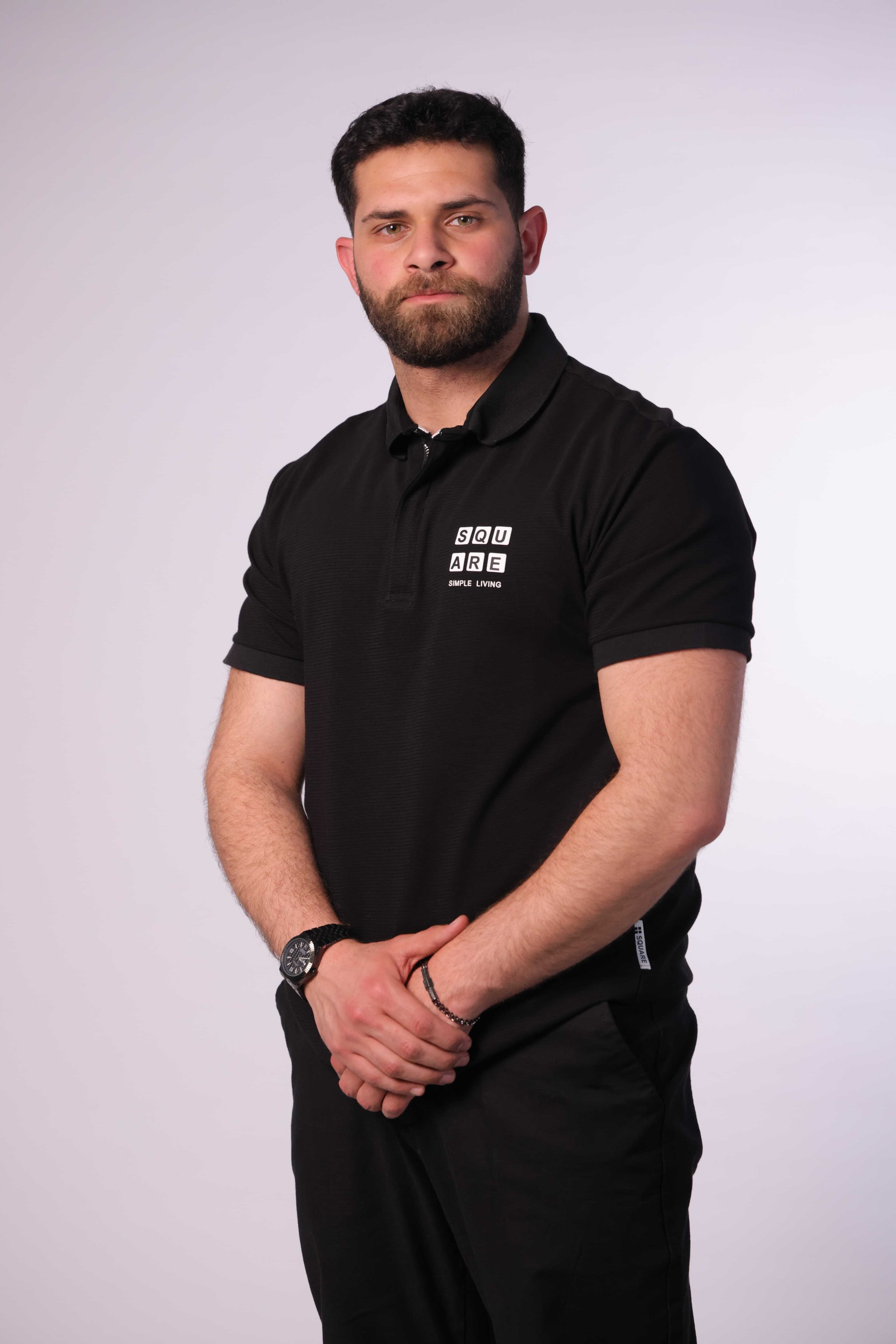Slim-Fit Black Polo Shirt - Slim-fit black polo shirt designed for a clean and modern look. Featuring a structured collar with a subtle zip placket and a minimal chest print detail for a refined touch. Crafted from soft, breathable fabric that offers comfort while maintaining a sharp silhouette—perfect for smart-casual outfits or elevated everyday wear.