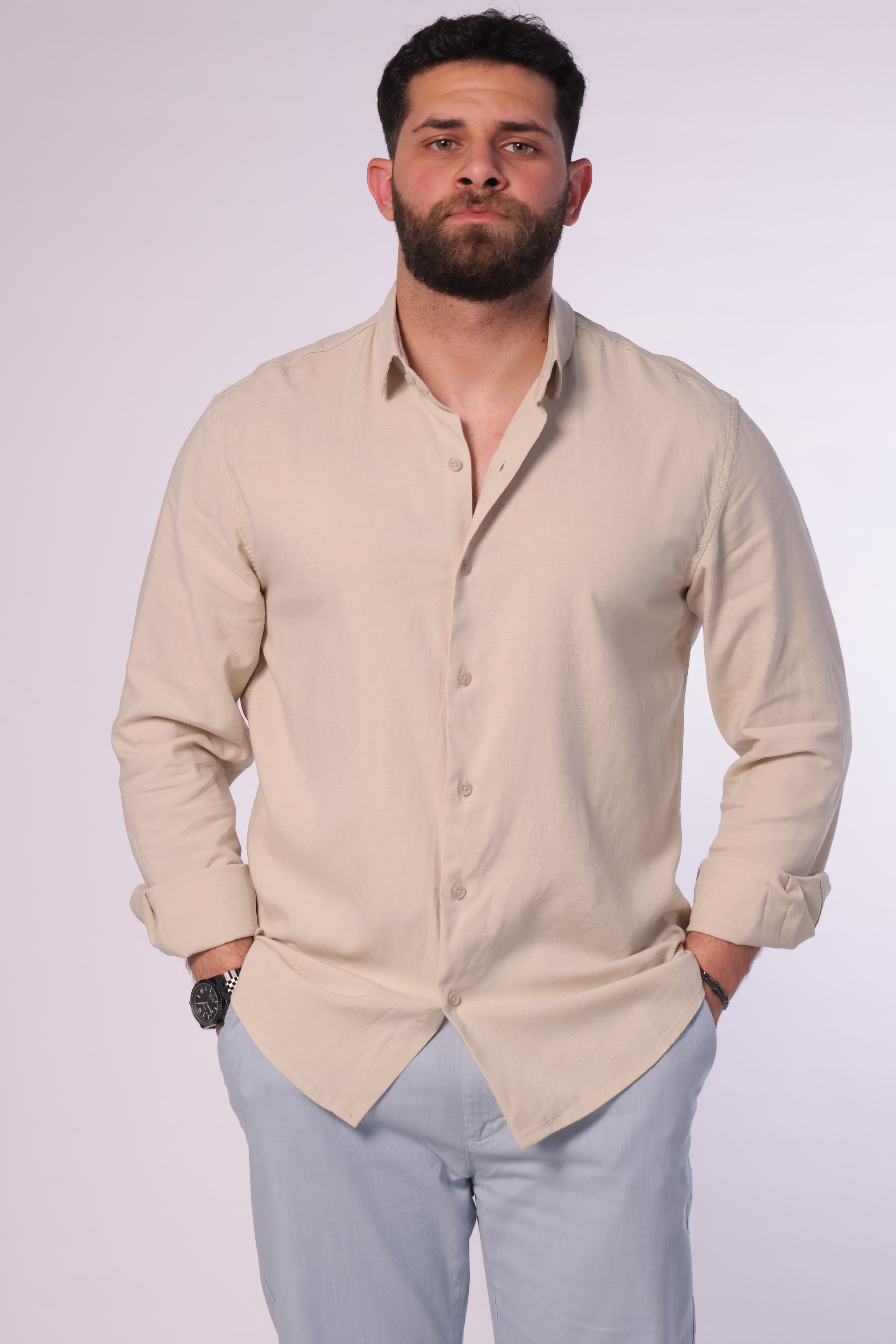 Regular-Fit Beige Button-Down Shirt - Regular-fit beige button-down shirt designed for a clean and refined look. Featuring a classic collar, full button closure, and a minimal, smooth finish for a timeless style. Crafted from lightweight, breathable fabric that offers all-day comfort while maintaining a sharp silhouette—perfect for smart-casual outfits or dressed-up everyday wear.
