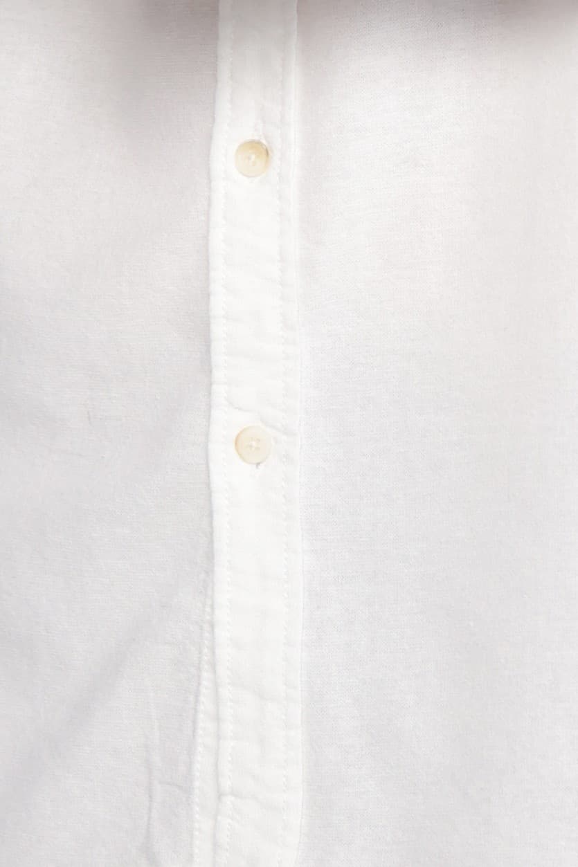 Relaxed-Fit Button-Down Shirt - Relaxed-fit white button-down shirt designed for a clean and effortless look. Featuring a classic collar, full button closure, and a soft, slightly textured fabric that adds a natural feel. Crafted from lightweight, breathable material for all-day comfort, making it perfect for smart-casual outfits or laid-back everyday styling.