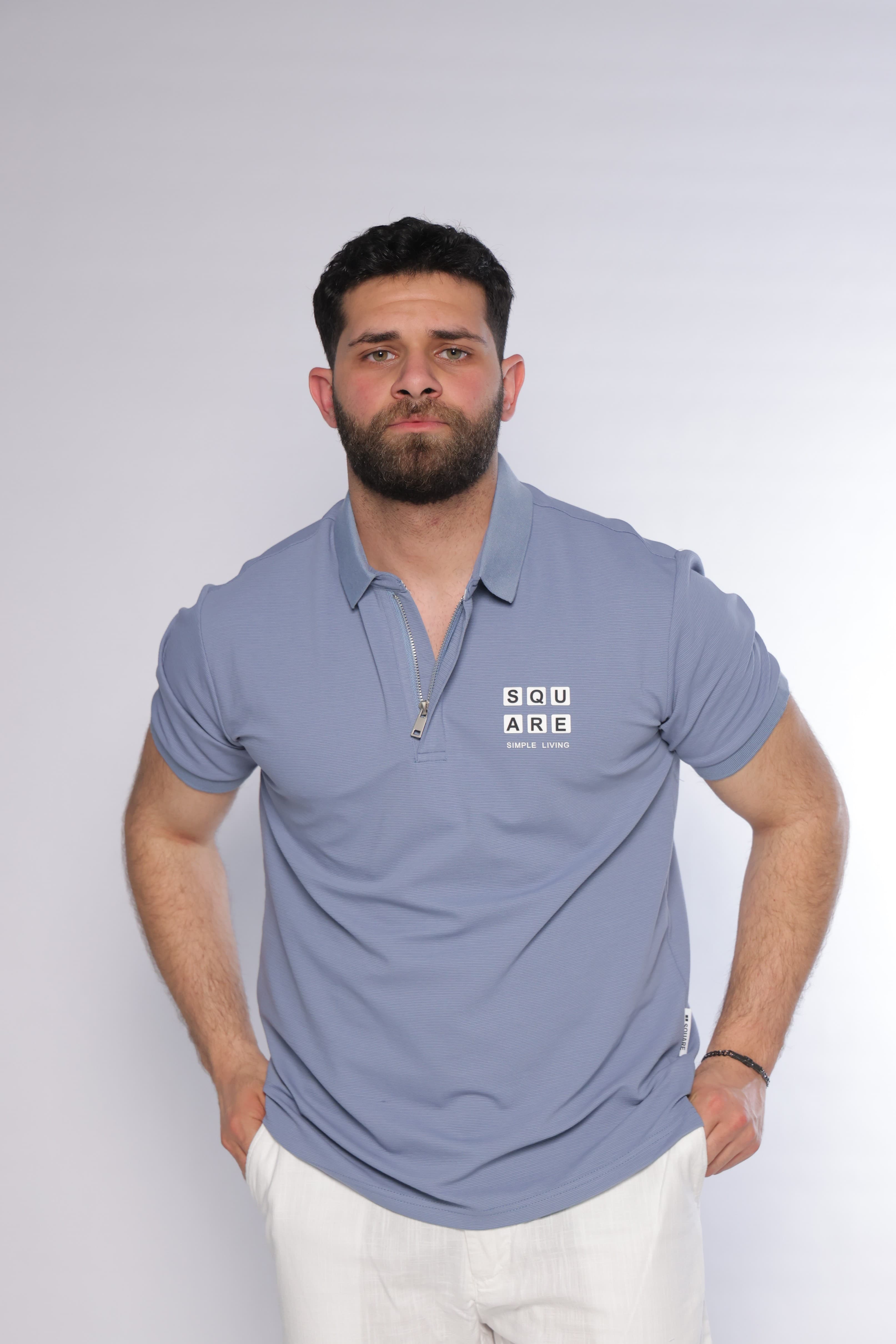 Regular-Fit Light Blue Polo Shirt - regular-fit light blue polo shirt designed for a clean and modern look. Featuring a structured collar with a sleek zip placket and a subtle chest logo detail for a refined touch. Crafted from soft, breathable fabric with a smooth textured finish, offering all-day comfort while maintaining a sharp silhouette—perfect for smart-casual outfits or elevated everyday wear.
