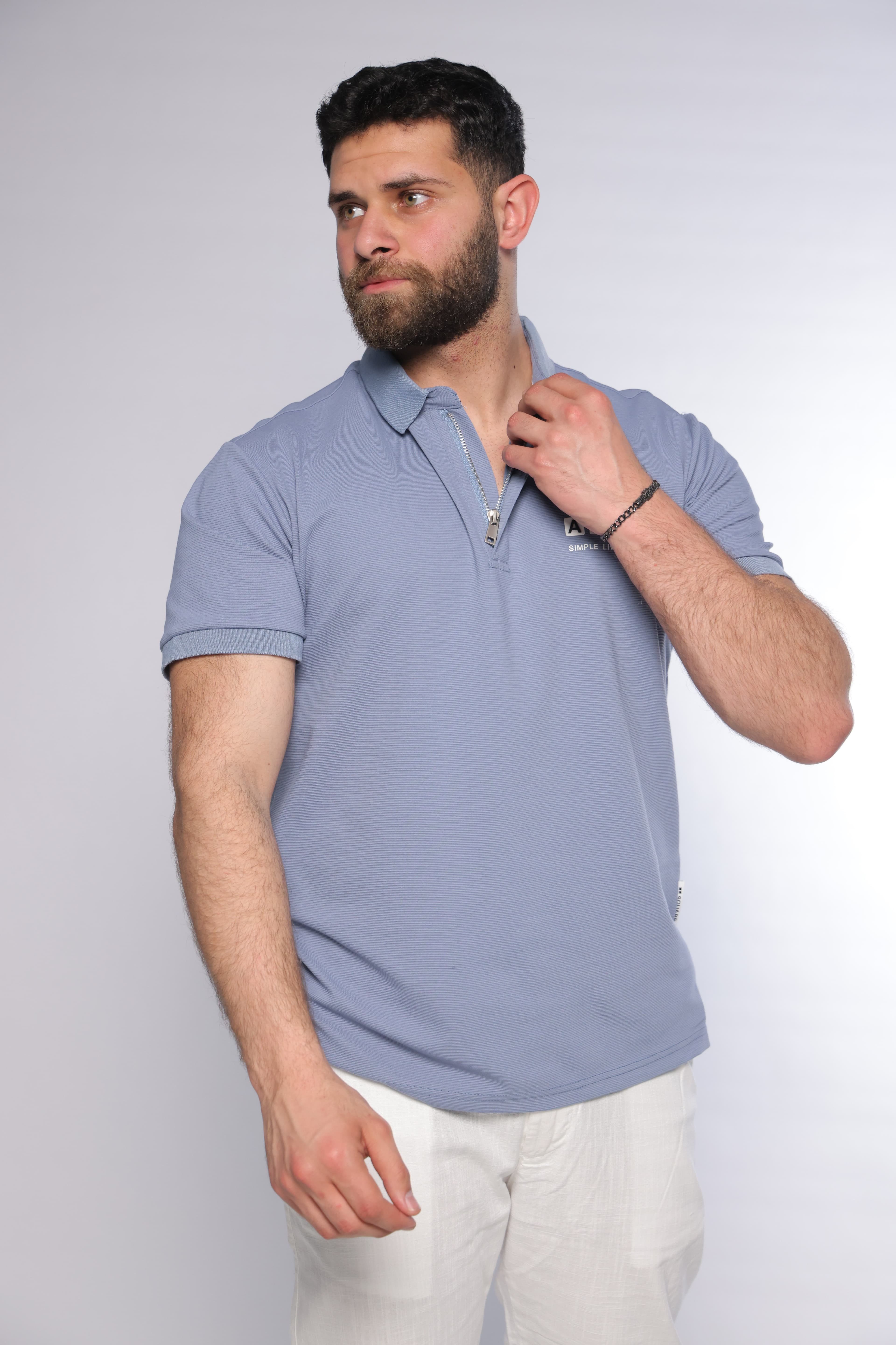 Regular-Fit Light Blue Polo Shirt - regular-fit light blue polo shirt designed for a clean and modern look. Featuring a structured collar with a sleek zip placket and a subtle chest logo detail for a refined touch. Crafted from soft, breathable fabric with a smooth textured finish, offering all-day comfort while maintaining a sharp silhouette—perfect for smart-casual outfits or elevated everyday wear.