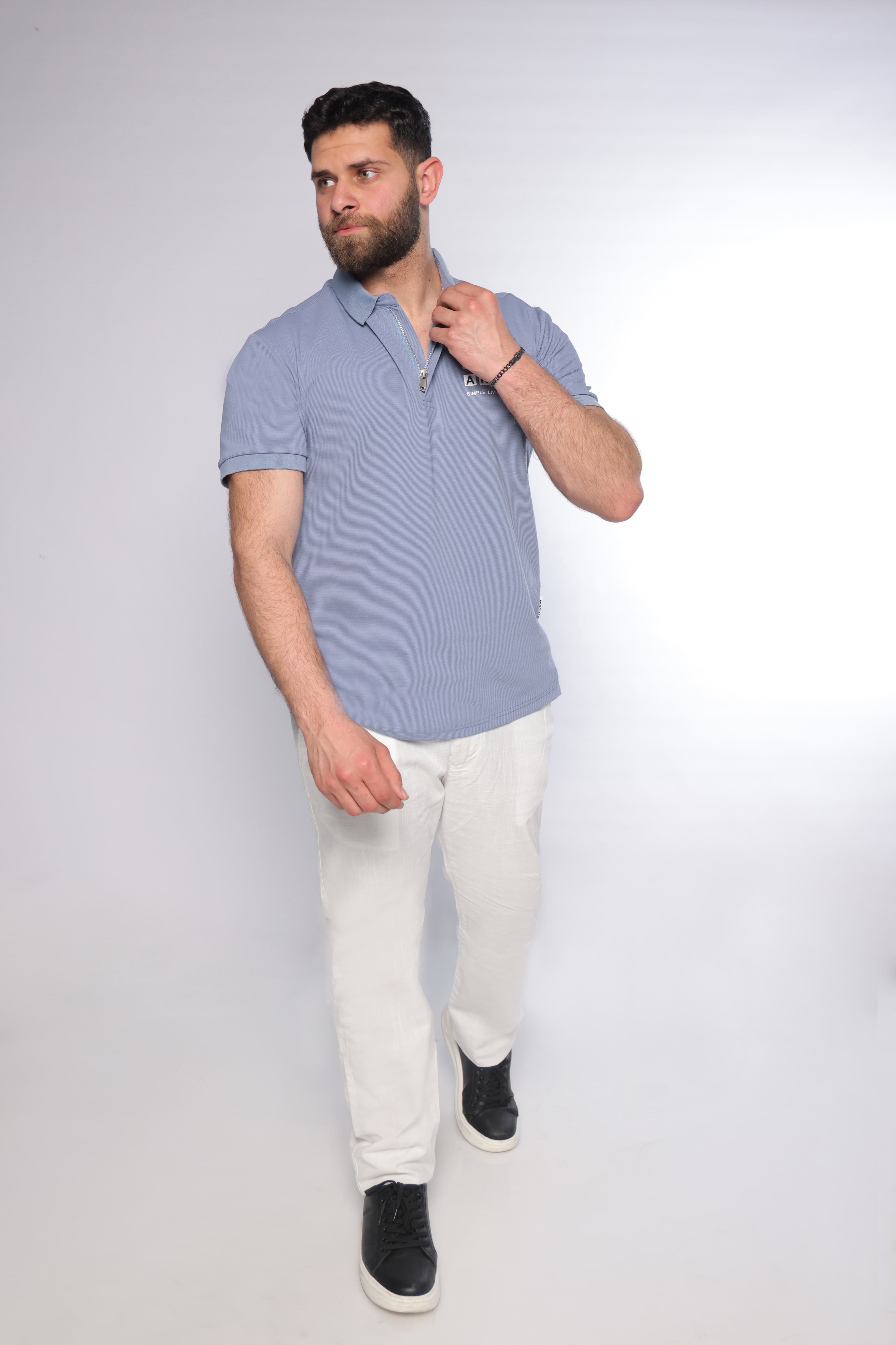 Regular-Fit Light Blue Polo Shirt - regular-fit light blue polo shirt designed for a clean and modern look. Featuring a structured collar with a sleek zip placket and a subtle chest logo detail for a refined touch. Crafted from soft, breathable fabric with a smooth textured finish, offering all-day comfort while maintaining a sharp silhouette—perfect for smart-casual outfits or elevated everyday wear.