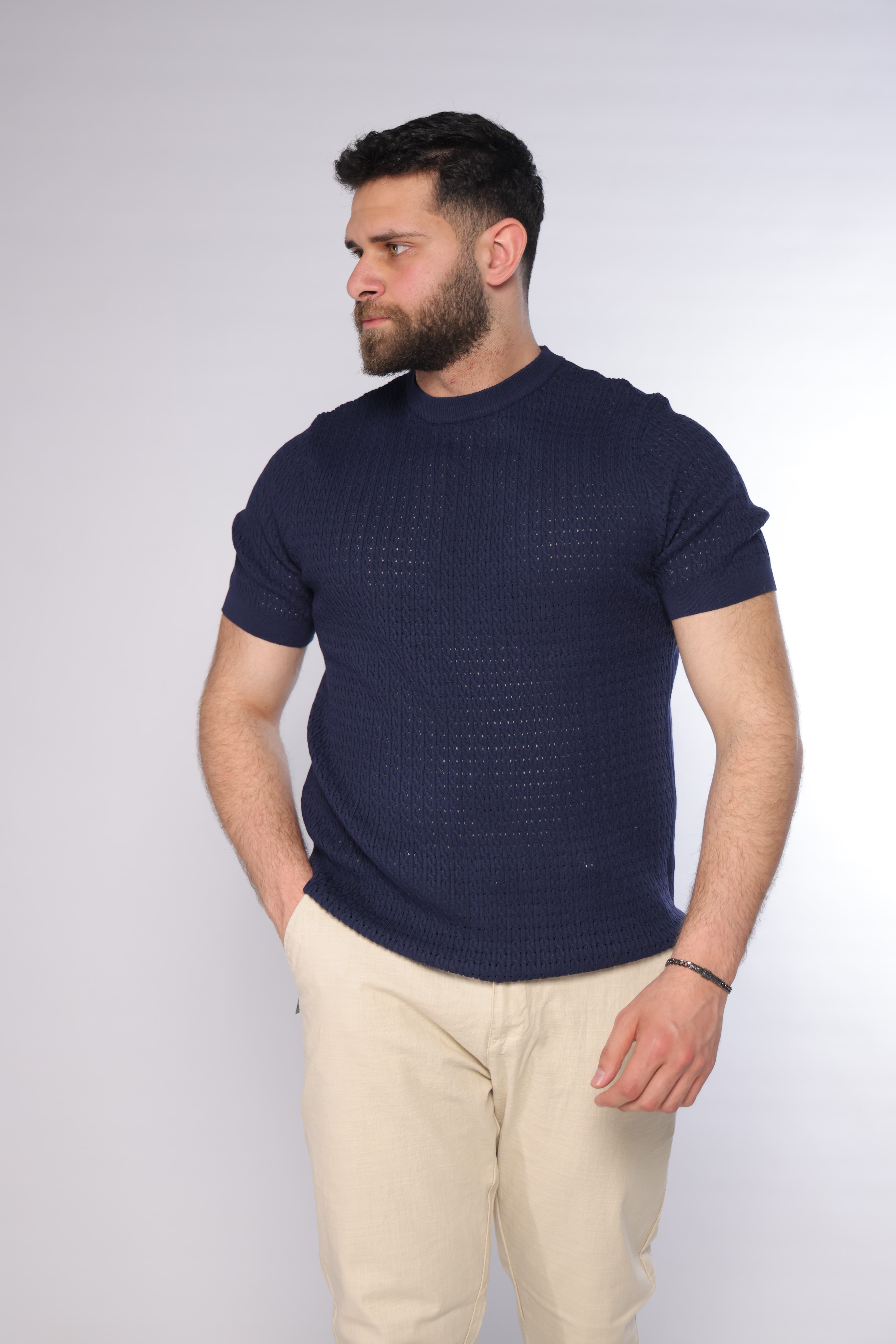 Slim-Fit Navy Knitted T-Shirt - Slim-fit navy knitted t-shirt featuring a textured open-knit pattern for a refined, breathable feel. Designed with a clean crew neckline and fitted short sleeves that enhance the silhouette. Crafted from soft, lightweight fabric, making it perfect for smart-casual looks or elevated everyday styling with a modern edge.