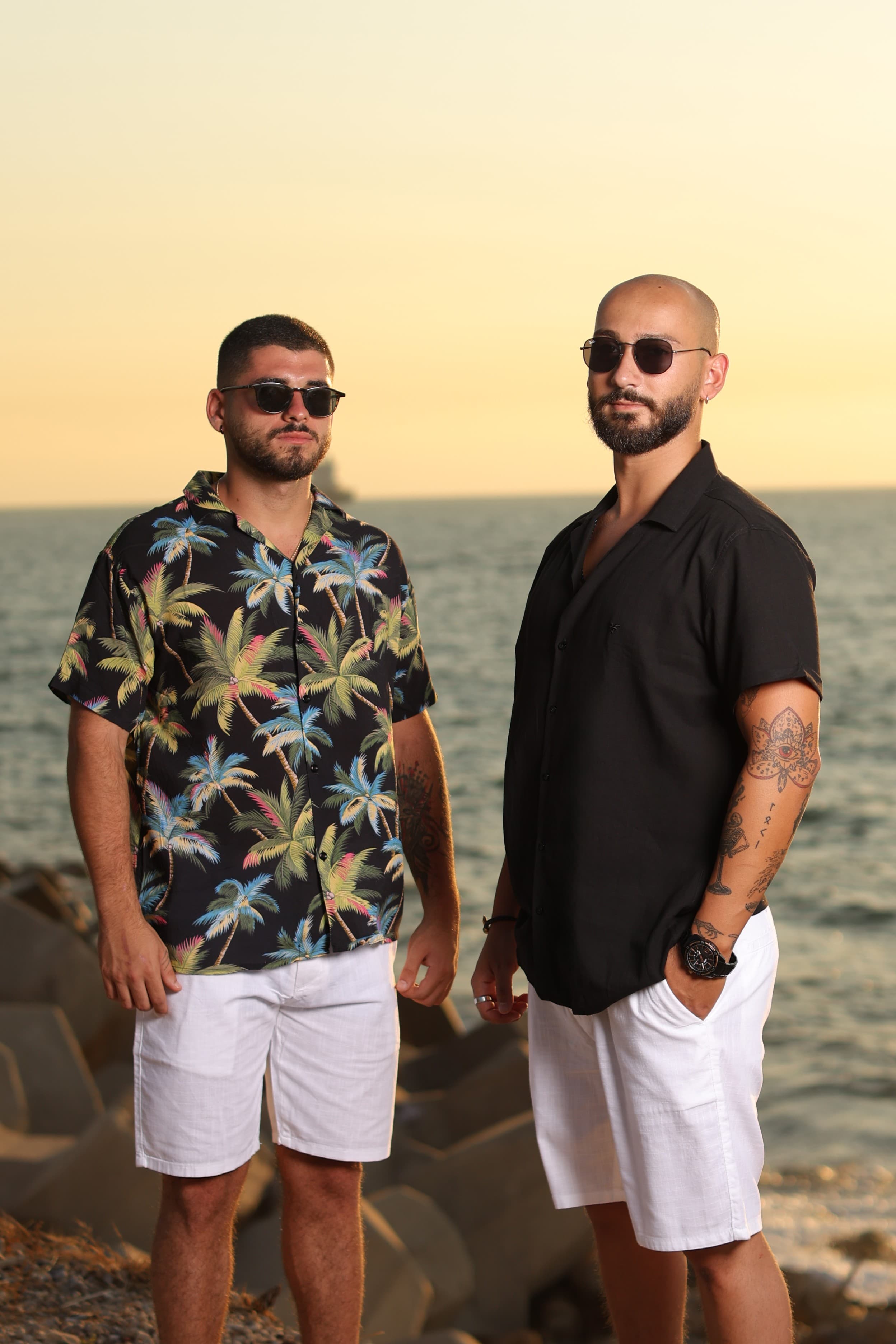 Relaxed-Fit Tropical Button-Down Shirt - Relaxed-fit short sleeve button-down shirt featuring a bold tropical palm print on a deep black base for a standout summer look. Designed with a camp collar and lightweight, breathable fabric for all-day comfort in warm weather. Perfect for beach days, vacations, or casual outings—bringing a vibrant, laid-back island vibe to your wardrobe.
